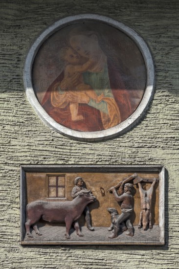 Relief depiction of a house slaughter above a saint at a town house, Going am Wilden Kaiser, Tyrol,