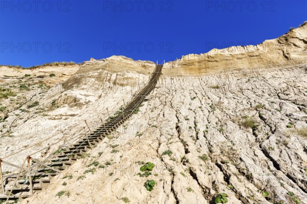 Extremely steep wooden staircase, steep coast down to the natural beach of the North Sea,