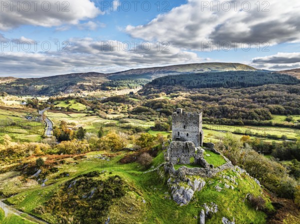 Autumn colours over Castell Dolwyddelan and Eryri Mountains from a drone, Snowdonia, Conwy County