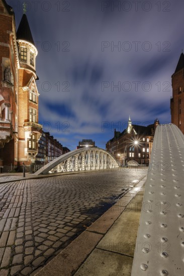 Blue hour in the Speicherstadt Hamburg on the Neuerwegsbrücke with cobblestones in the foreground