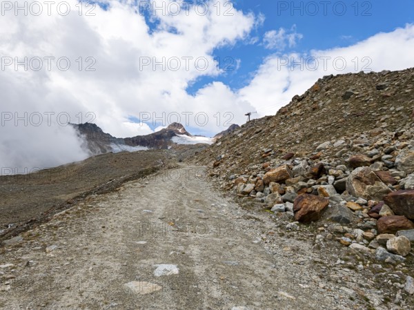 Mountain hiking trail in alpine mountain scenery in the area of the Tiefenbach Glacier near Sölden,