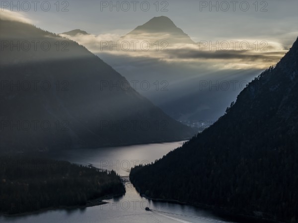 Mountain lake, mountains, sunrays, back light, fog, boat, sightseeing boat, evening light, Plansee,