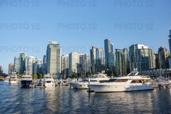 Sailing boats in marina, skyscrapers on the promenade, Coal Harbour, Vancouver, British Columbia,