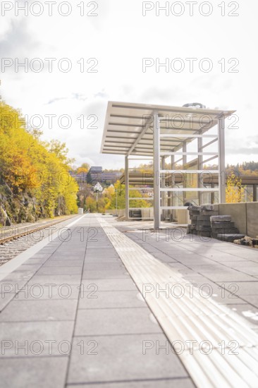 Abandoned platform in autumn with yellow trees and modern construction, ZOB Calw, Hermann