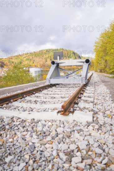 Railway line with rail stopper in autumn landscape under cloudy sky, ZOB Calw, Hermann Hessebahn,