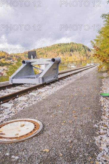 End of train tracks with autumnal mountain landscape and cloudy sky, ZOB Calw, Hermann Hessebahn,