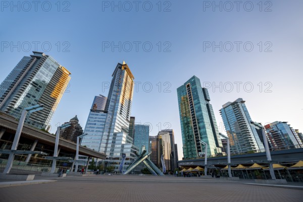 Olympic Cauldron Statue, Jack Poole Plaza Square, skyscrapers on the promenade at sunset, Coal