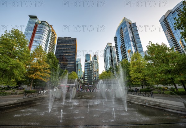 Fountain in Spray Park and SkyLine with skyscrapers at sunset, Harbour Green Park, Vancouver,