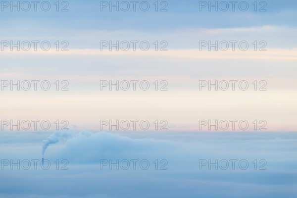 Inversion weather, fog, sunrise, autumn, view from Breitenstein of smoking chimney sticking out of