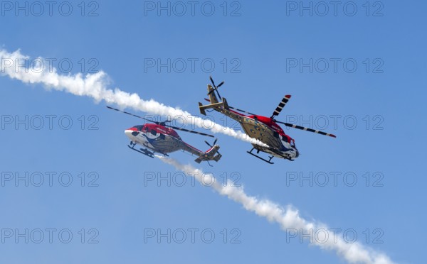 Indian Air Force (IAF) ALH Mk1 Sarang helicopters soar through the sky during an air show as part
