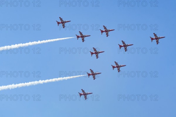The Indian Air Force (IAF) Surya Kiran aerobatics team performs during an air show as part of the