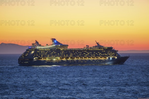 Mykonos, Cyclades, Greece - Voyager of the Seas cruise ship sails from Mykonos harbour bay towards