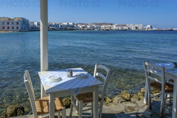 Mykonos, Cyclades, Greece - Small picturesque tavern right on the waterfront, on the harbor in the