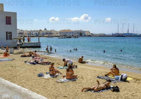 Mykonos, Cyclades, Greece - Tourists and locals like to bathe at the small town beach Paralia