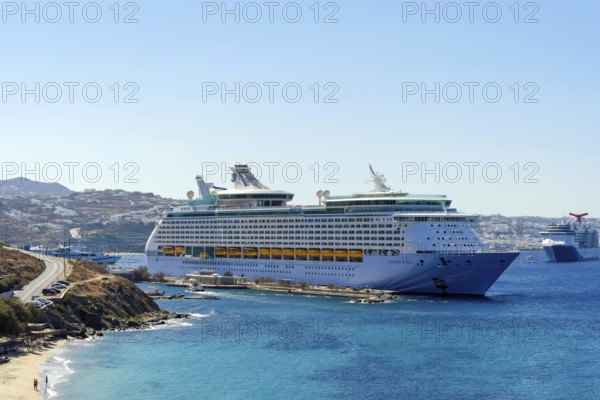 Mykonos, Cyclades, Greece - Voyager of the Seas cruise ship is located in Mykonos Harbour Bay. In