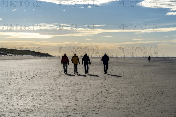 Walkers on the Wadden Sea near the East Frisian island of Spiekeroog, west of the North Sea island,