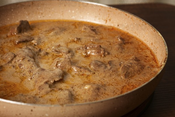 Beef stroganoff, pan cooking, close-up, homemade