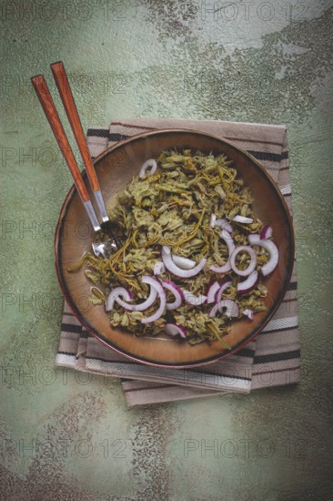 Jonjoli, Colchian klekachka, jonjoli salad, with red onion and butter, Georgian appetizer, pickled