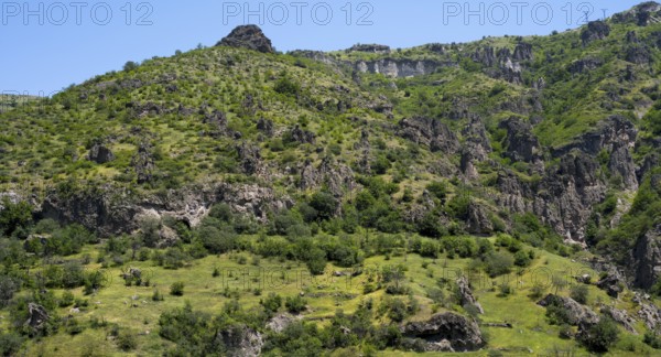 Green hills and rocky landscape under a clear summer sky, landscape near Goris, Hoodoos, Syunik