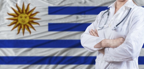 Doctor with crossed arms on Uruguay flag. Uruguay health and care concept. Female doctor on Uruguay