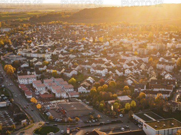 Closely standing houses in a city at autumn sunset, roads visible, Grossbottwar, Germany