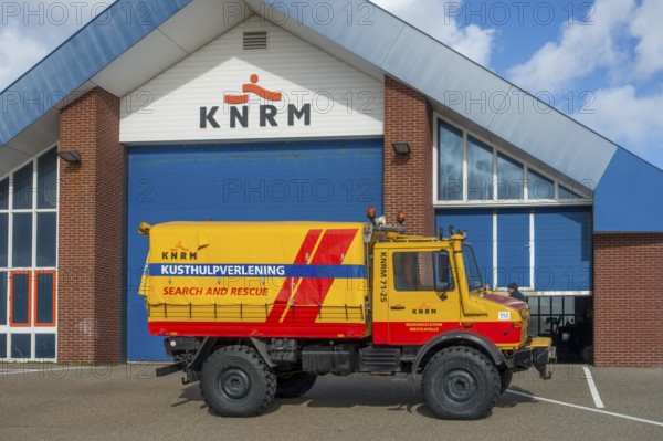 KNRM Mercedes-Benz Unimog 435 truck in front of sea search and rescue lifeboat station at