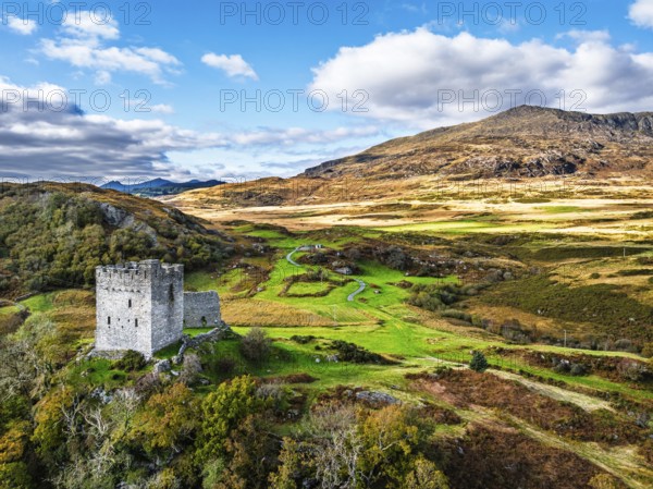 DefaAutumn colours over Castell Dolwyddelan and Eryri Mountains from a drone, Snowdonia, Conwy