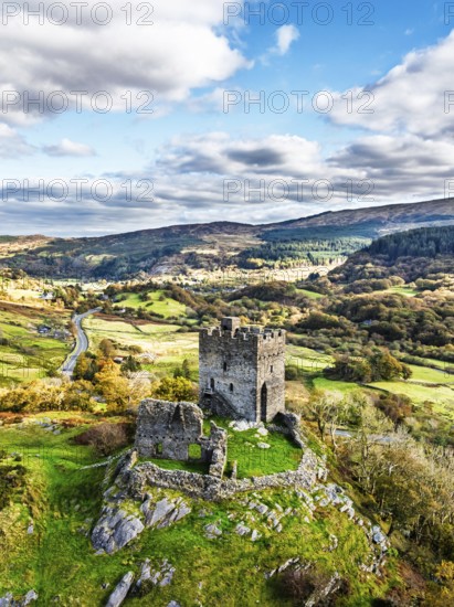 Autumn colours over Castell Dolwyddelan and Eryri Mountains from a drone, Snowdonia, Conwy County