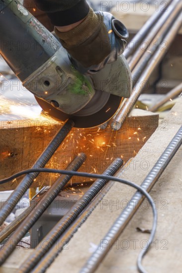 A worker cuts metal bars with a flex, sparks spray, construction of Hermann, Hesse, Bahn, Calw,