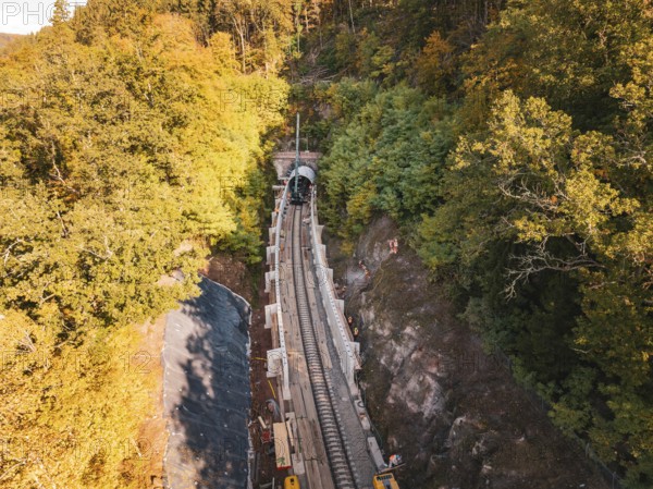 Aerial view of an autumn rail construction site in the forest, Hermann building, Hesse, railway,
