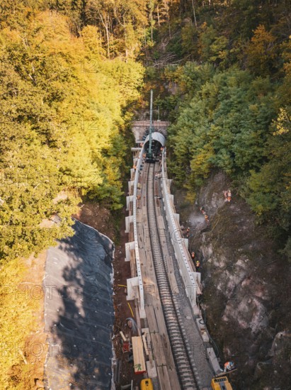 Autumn forest construction site taken from the air with a tunnel boring machine, construction of