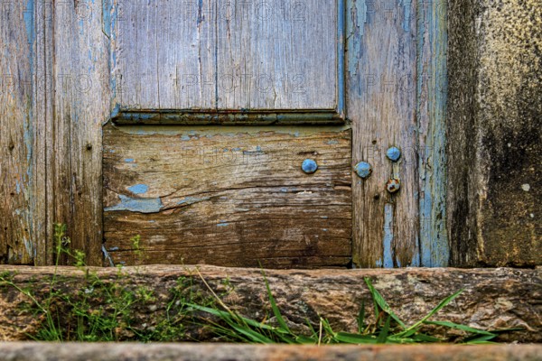 Details of an old baroque church door made of wood, weathered by time, in Ouro Preto city, Ouro