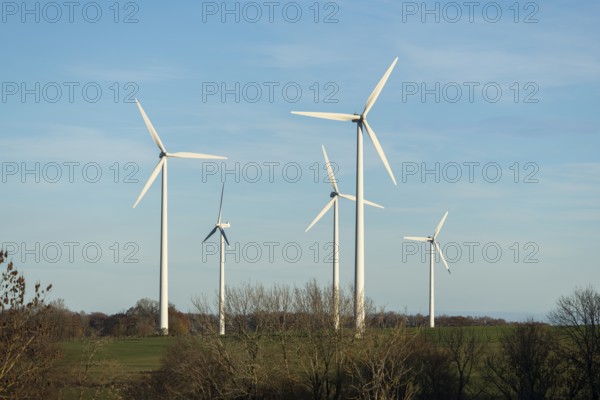 Wind turbines stand on a wide meadow under a clear blue sky, Swabian Jura, Baden-Württemberg,