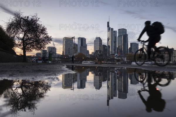 Frankfurt's banking skyline is reflected in a puddle in the evening, Frankfurt am Main, Hesse,