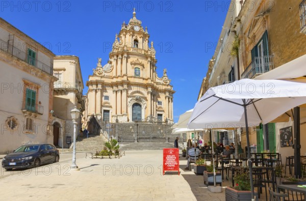 Tourists sitting in local restaurants in the main square, Ragusa Ibla, Ragusa province, Sicily,