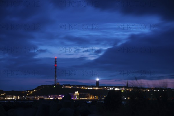Panoramic view, view of the highlands of the island of Heligoland at night with red-lit radio