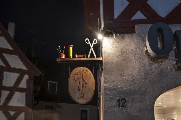 Nocturnal view of a tailor shop's nose shield, Lauf an der Pegnitz, Middle Franconia, Bavaria,