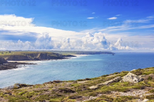 Seascape view at a seabay on a rocky coastline a sunny summer day by the sea with dramatic clouds