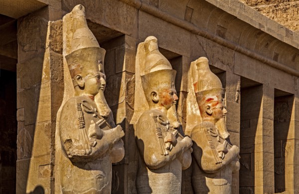 Osiris statues of Hatshepsut on the second terrace - partly with original paint remains, mortuary