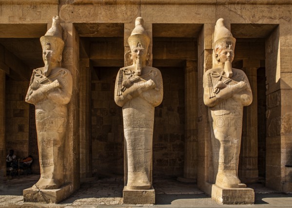 Hatshepsut's larger-than-life (5 m) Osiris statues in the middle colonnade, statues in the robe of