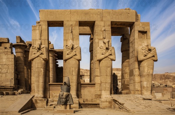 2nd courtyard with Osiris statues, head of a statue of Ramesses II in front of it, Ramesses II