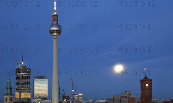 The moon shines on Alexanderplatz, St. Mary's Church, The Berlinian skyscraper construction site,