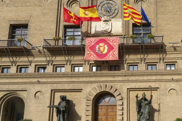 Flags flying Ayuntamiento city hall building, Plaza del Pilar, city centre of Zaragoza, Aragon,