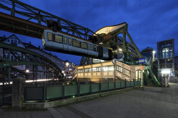 The Wuppertal suspension railway goes to the Werther Brücke stop, Wuppertal, Germany at blue hour,