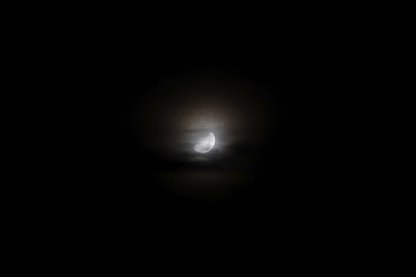 Moon at night behind veil clouds, autumn, Germany