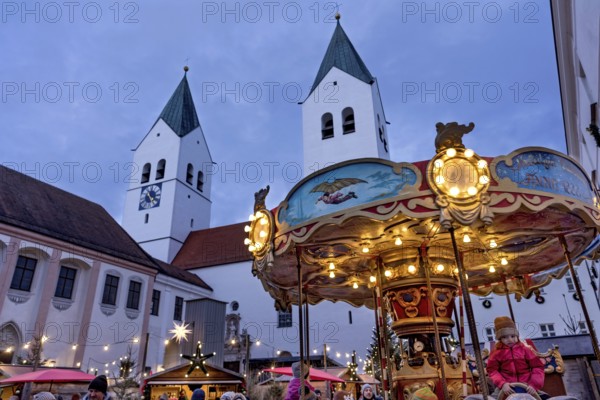 Illuminated old children's carousel, historic nostalgia carousel year 1888, Christmas market,