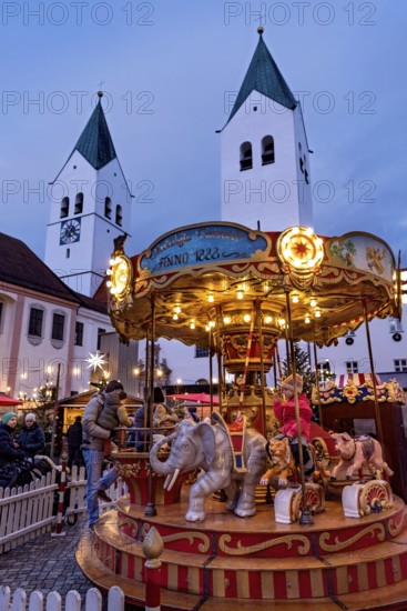 Illuminated old children's carousel, historic nostalgia carousel year 1888, Christmas market,