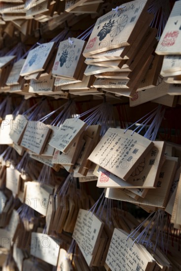 Ema, small wooden tablets with wishes and prayers, hung so that the Kami spirits or gods can