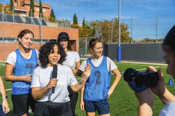 Female football player talking into a microphone, sharing her thoughts and insights about the