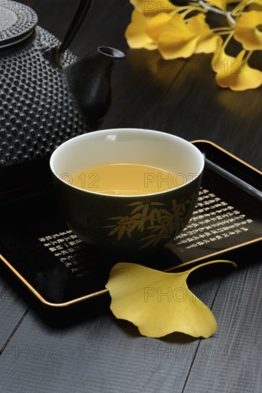 Ginkgo tea in tea bowl and ginkgo leaf, ginkgo biloba